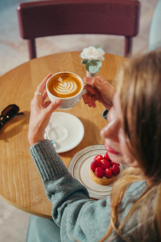 Guest with a latte and a raspberry tart