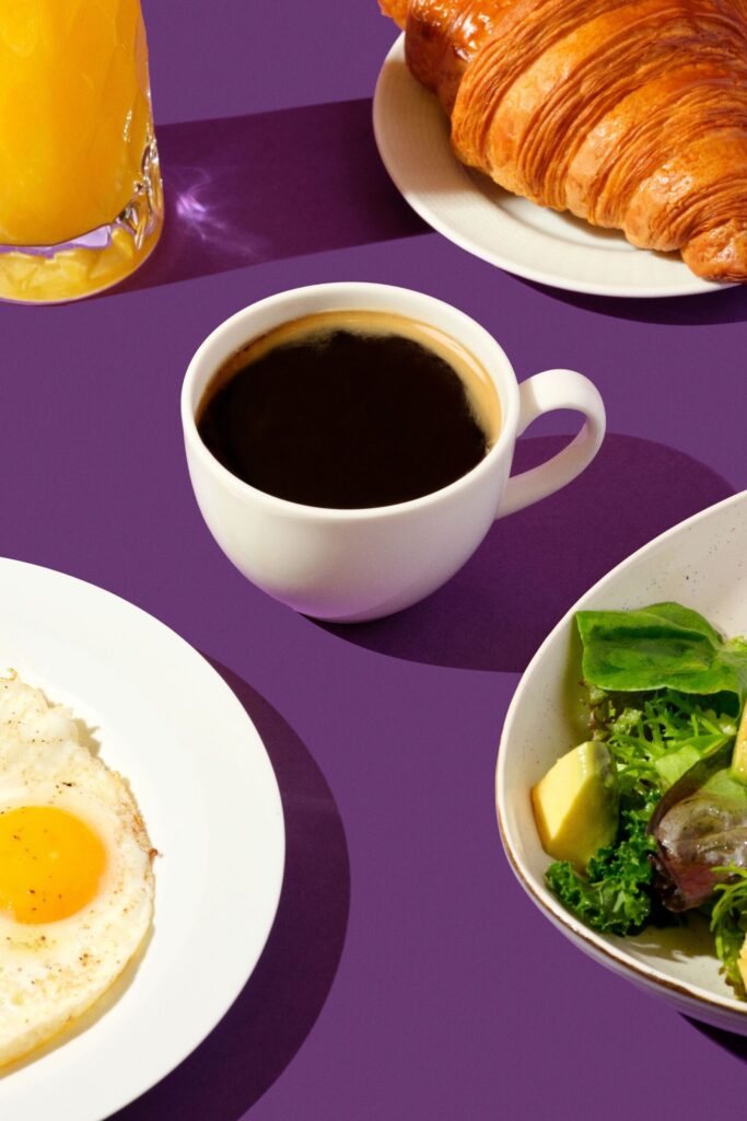 Coffee, croissant and a breakfast plate