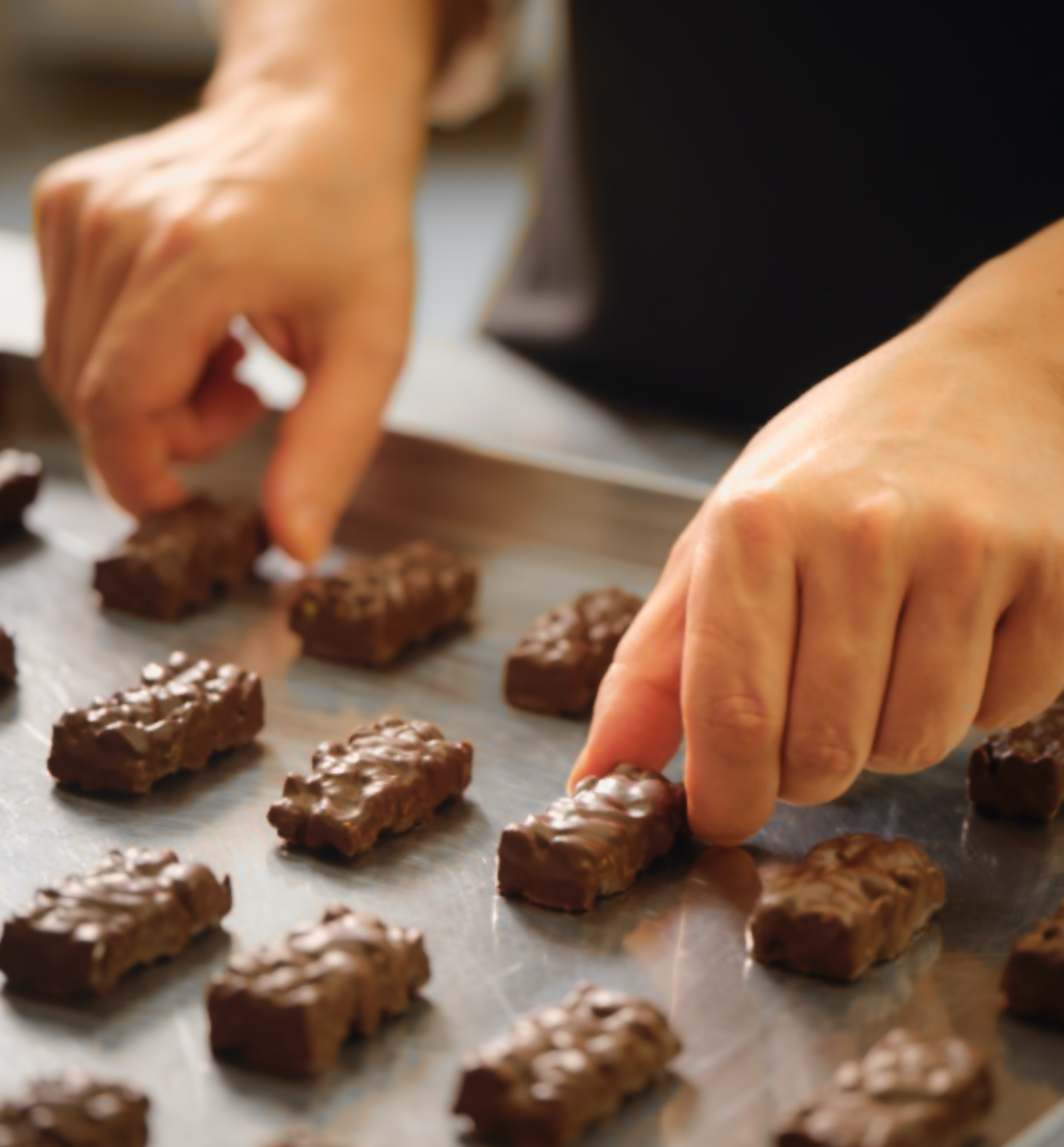 Handmade chocolates being arranged on a tray